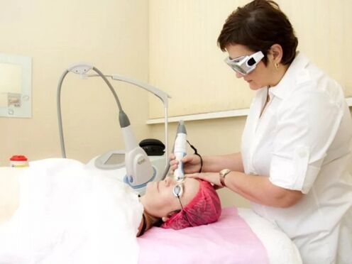 A cosmetologist performs a laser rejuvenation procedure